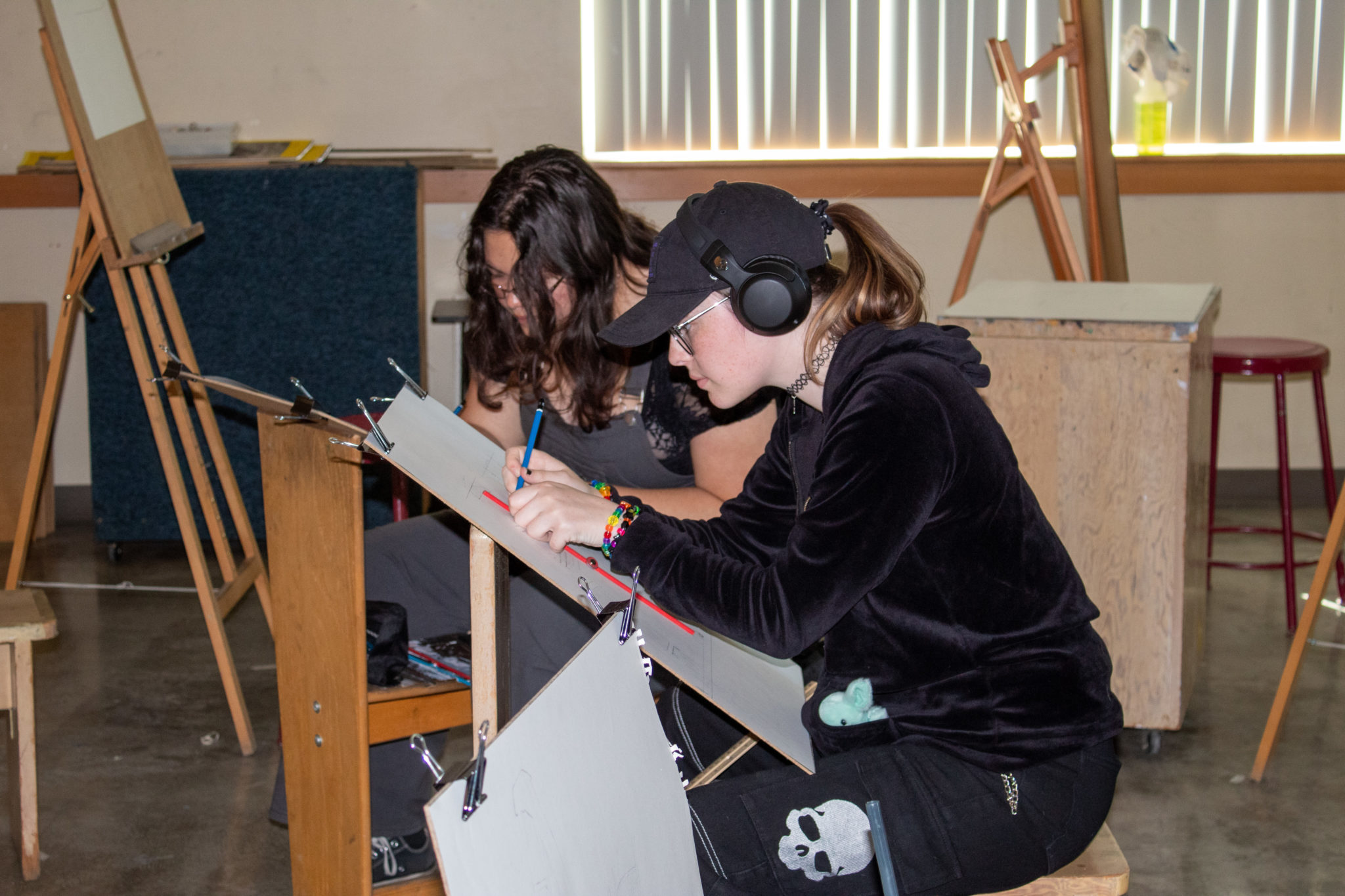 Two students working on drawing project for Art 104.