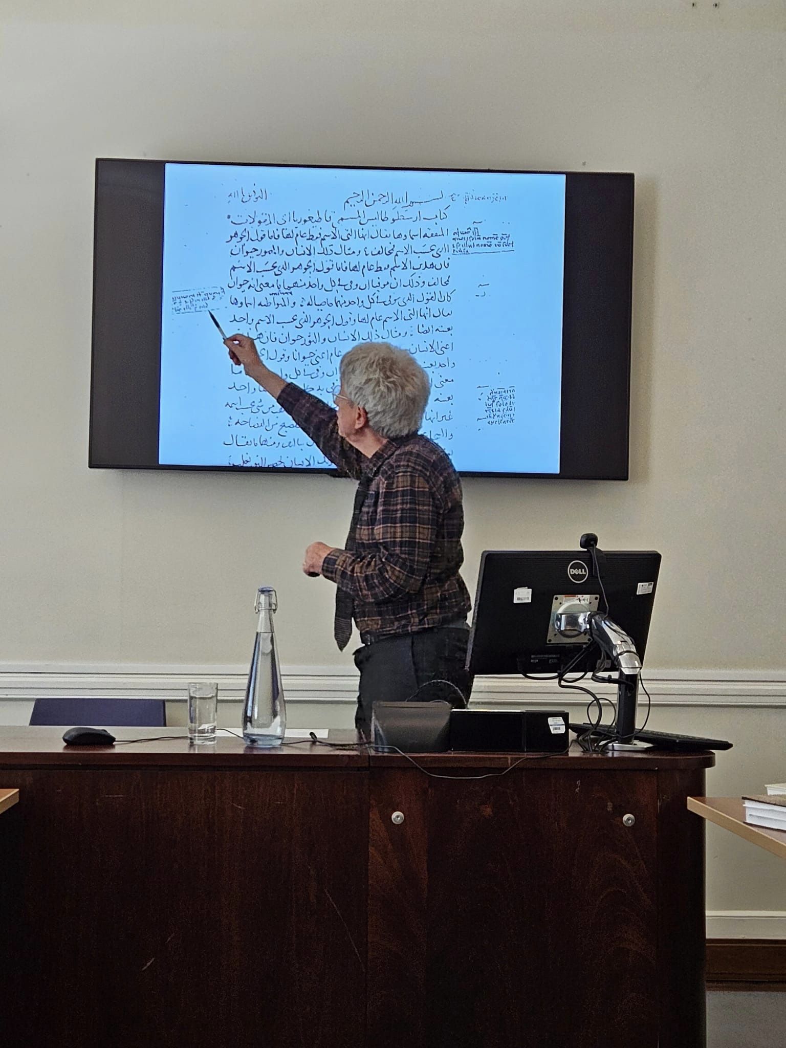 A man points to words on a screen.